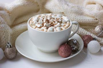 Christmas or New Year background with white cup of hot cocoa with marshmallows.