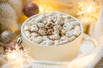 Christmas or New Year background with white cup of hot cocoa with marshmallows.