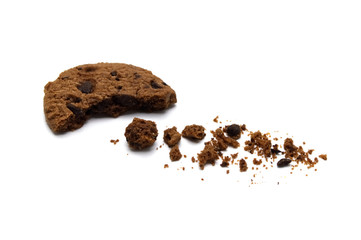 Chocolate chip cookies and crumbs on white background.