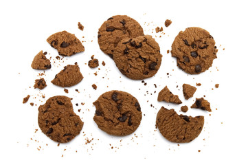 Chocolate chip cookies with some broken and crumbs on white background in Top view.