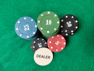 Top view of poker chips on the table on the green baize.