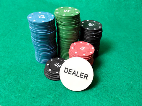 Poker Chips On The Table On The Green Baize.