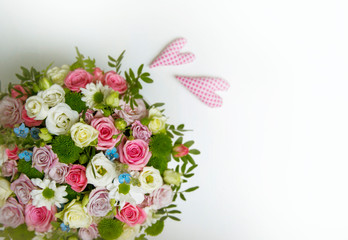 Bouquet of flowers with two hearts on white background