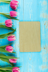 Pink tulip flower on blue wood table background with copy space for text. Love, International Women day, Mother day and Happy Valentine day concept