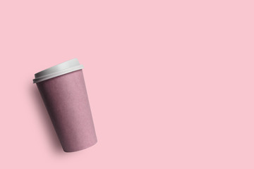 Simply flat lay design pink paper coffee cup isolated on pink pastel colorful background