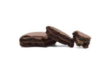 Chocolate sandwich cookies filled and coated with chocolate cream isolated on white background.