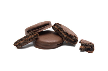 Chocolate sandwich cookies filled and coated with chocolate cream isolated on white background.