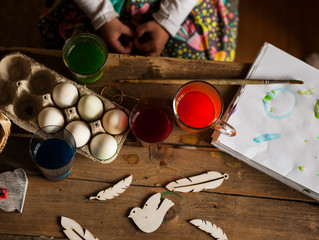 little girl paints  easter eggs/easter background