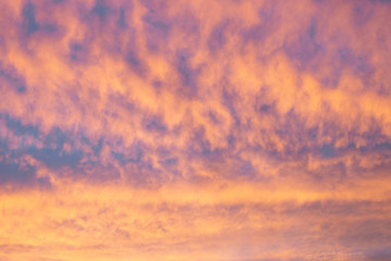 Naklejka na ściany i meble Painted by nature's colors, the sky of dawn or sunset. Bright colors of orange, violet and blue.
