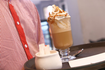 close of man serving coffee at cafe restaurant 
