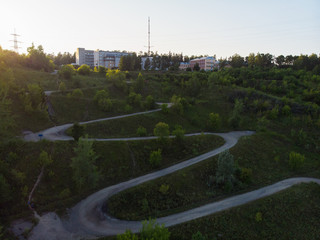 Aerial top vew of winding road in the city, drone shot