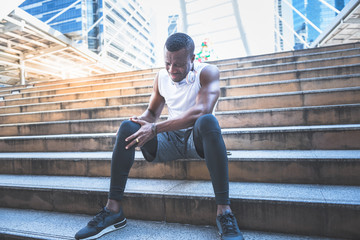 A 31 year old African American man with black skin he is and athlete, currently having a knee...