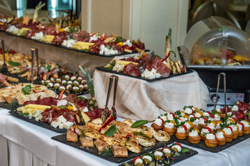 Catering buffet table with cold snacks. Delicious appetizers on the table, self serve.