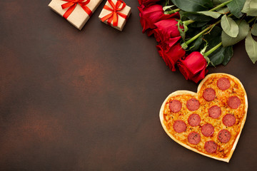 Top view arrangement for valentines day with heart shaped pizza and copy space