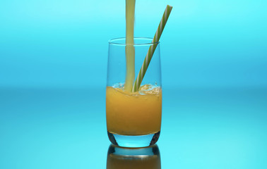 Fresh orange juice pouring into a glass