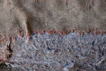 Old burlap and batting. Protruding threads. Conceptual background for design.