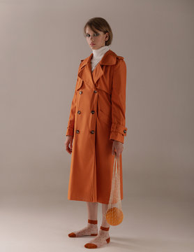  Girl in an orange trench coat with melon and lemon