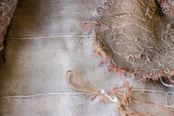 Old burlap and batting. Protruding threads. Conceptual background for design.