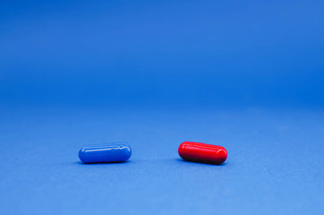 red and blue pills on a blue background