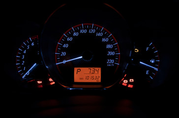 The yellow status display of car speedometer the miles, time and gear is in the car's night watch....