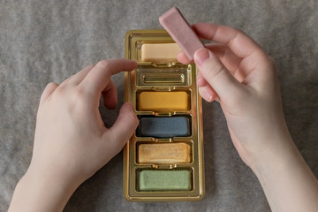 Edible multi-colored plasticine from marzipan in the hands of a girl for decorating baking....