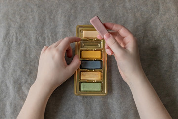 Edible multi-colored plasticine from marzipan in the hands of a girl for decorating baking....