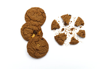 Biscuit with chocolate chip flavored. Some broken and crumbs of crunchy delicious sweet meal and useful cookie with on white background.
