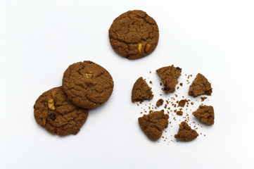 Biscuit with chocolate chip flavored. Some broken and crumbs of crunchy delicious sweet meal and useful cookie with on white background.