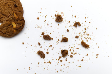 Biscuit with chocolate chip flavored. Some broken and crumbs of crunchy delicious sweet meal and useful cookie with on white background.