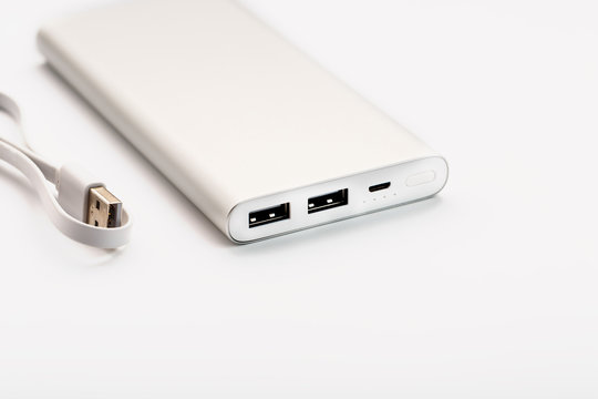 Powerbank for charging mobile devices with cable, on a white background.