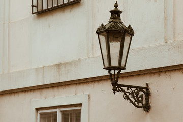 Fototapeta na wymiar Prague. 05.10.2019: Prague street lamp. Wrought iron flashlight on the background wall of an ancient building.