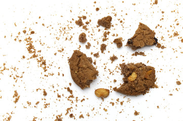 Cookies with chocolate chip flavored. Some broken and crumbs of crunchy delicious sweet meal and useful biscuits on white background.
