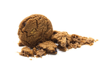 Cookies with chocolate chip flavored. Some broken and crumbs of crunchy delicious sweet meal and useful biscuits on white background.