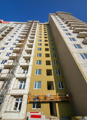 A fragment of a multi-storey building under construction insulated with plates of heat-insulating...