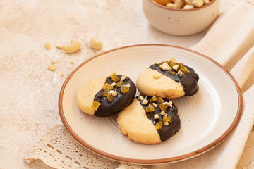 crumbly vanilla-chocolate homemade cashew cookies and mango marmalade on a light beige background. natural sweets. cozy tea party concept