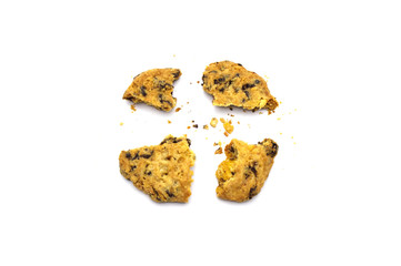 Homemade Oatmeal Raisin Cookies cracked and crumbs isolated on white background.