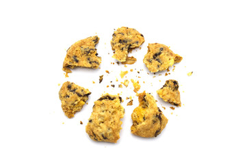 Homemade Oatmeal Raisin Cookies cracked and crumbs isolated on white background.
