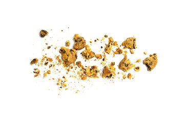 Scattered crumbs of homemade oatmeal raisin cookies isolated on white background.