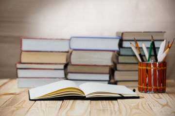 Fototapeta na wymiar Textbooks and books on a wooden table