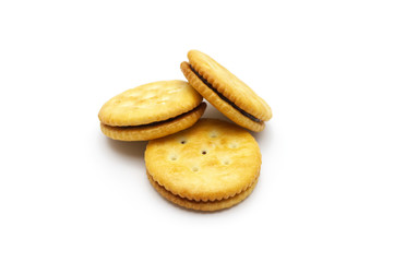 Biscuit sandwich cracker chocolate cream flavoured. Pile of crunchy delicious sweet meal and useful cookies on white background. Selective focus.