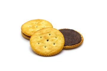 Biscuit sandwich cracker chocolate cream flavoured. Inside and outside of crunchy delicious sweet meal and useful cookies on white background. Selective focus.