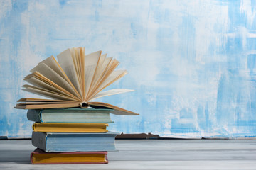 Open book, hardback books on wooden table. Back to school. Copy space