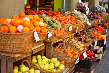 Shop window. Fresh vegetables and fruits in baskets. Market place. Space for a text.