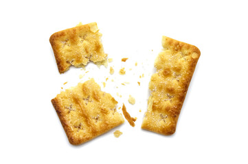 Broken square crackers biscuits isolated on white background. Crushed dry snack.