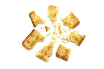 Broken square crackers biscuits isolated on white background. Crushed dry snack.