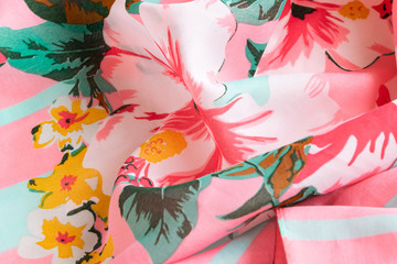 Fresh colorful folded cloth. Crop view of fashioned botanical fabric, pink and blue pastel colors