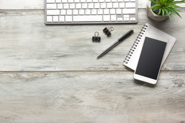 White desk office with laptop, smartphone and other work supplies with cup of coffee. Top view with copy space for input the text. Designer workspace on desk table essential elements on flat lay