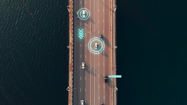 Autonomous Self Driving Cars Concept. Aerial view of cars moving on city bridge over river, scans road with sensors and control vehicles in traffic. Future Transportation concept