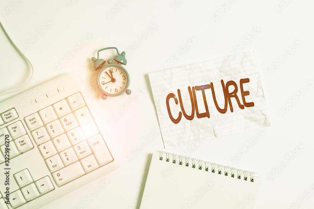 Aufkleber Conceptual hand writing showing Culture. Concept meaning characteristics and knowledge of a particular group of showing Paper with copy space on table with clock and keyboard