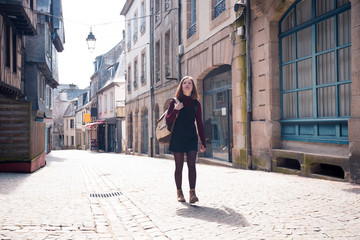 Fototapeta na wymiar girl is walking in the old town Morlaix